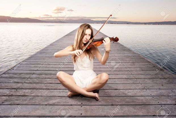 17573465-little-girl-playing-violin-on-a-wharf-Stock-Photo-music